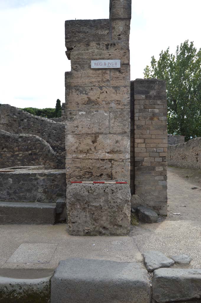 Street altar outside II.2.1 Pompeii. October 2018. 
Looking towards west side of entrance doorway, with a street altar in front of the pilaster.
Foto Taylor Lauritsen, ERC Grant 681269 DCOR.
