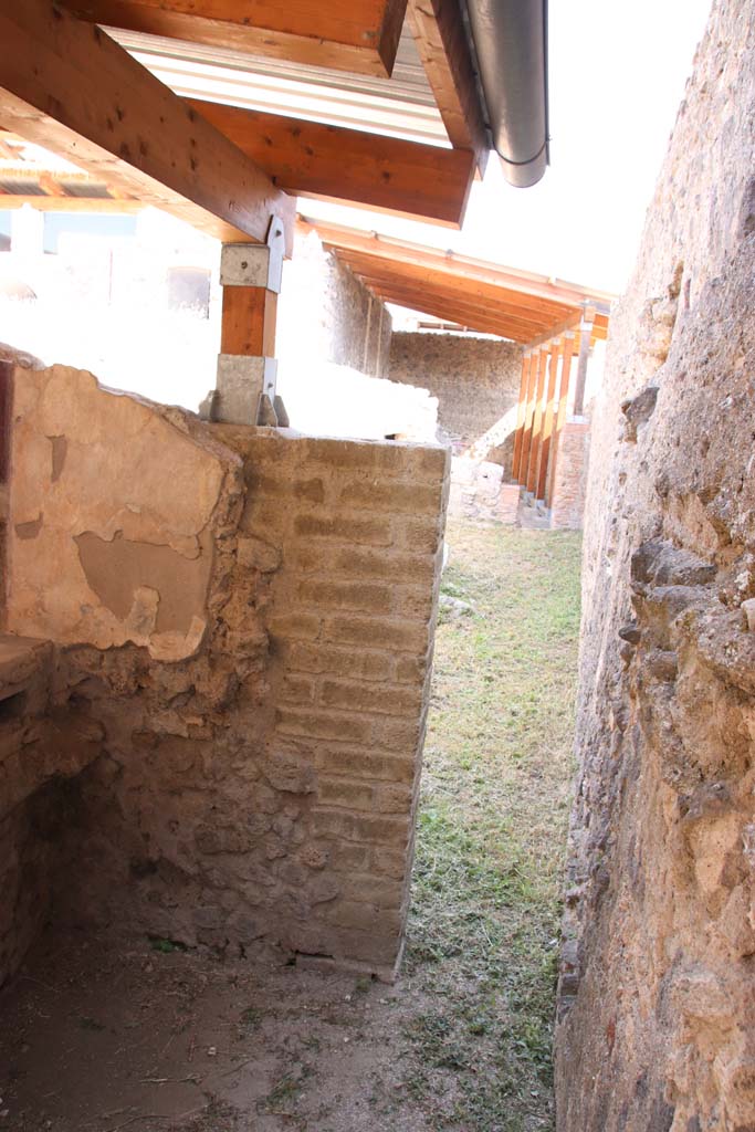 I.6.2/16 Pompeii. September 2019. 
Looking towards south end of east wall and through doorway along south side of garden area.
Photo courtesy of Klaus Heese.
