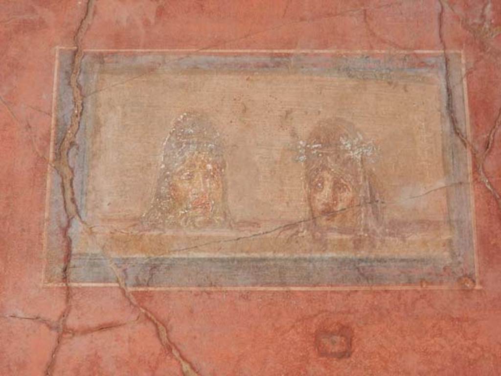 I.10.4 Pompeii. May 2015. North wall in north-east corner of atrium, detail of painted panel with theatrical masks. Photo courtesy of Buzz Ferebee.
