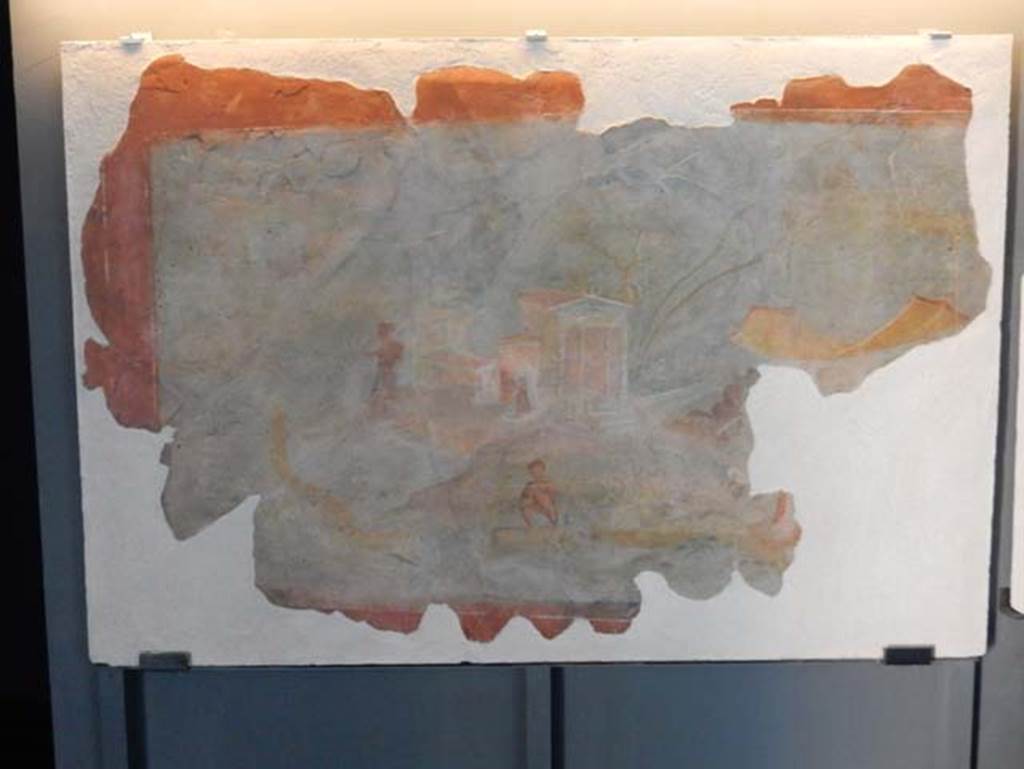 I.11.15, Pompeii. May 2016. 
Fragment of Nilotic scene which decorated the parapet of the upper floor balcony, found 1952-53. Photo courtesy of Buzz Ferebee.
The display card states that both fragments were once part of a single large fresco.
According to Grete Stefani, the painting (SAP 56310a) is very interesting and has only recently been made known to scholars.
Detached from a wall of Pompeii in an unspecified period, it was preserved, without any indication of its provenance, in the Pompeii Excavations' Restoration Workshop and, despite the efforts made, it had so far not been able to trace the original location of the painting. 
New data presented here, on the other hand, may help to clarify, in addition to the provenance, some iconographic aspects.
In fact, the photographic documentation of 1953 relating to the painting is preserved at the Photographic Archive of the Superintendence when it was still on site on the external side of the opus craticium wall that delimited the balcony on the upper floor of the house of Pompeii I 11, 15 (Photo SAP A 1522, Fig. 4); the painting also included a portion with hippos, now restored as a panel in its own right and whose relevance had been lost and a contiguous portion, now lost.
See Stefani, G. 2010. Luoghi e Personificazioni di luoghi nelle Pitture dell'area Vesuviana: AIPMA 2010, p. 258, fig. 4.
Our thanks to Domenico Esposito for his help in verifying the provenance of these fragments.

