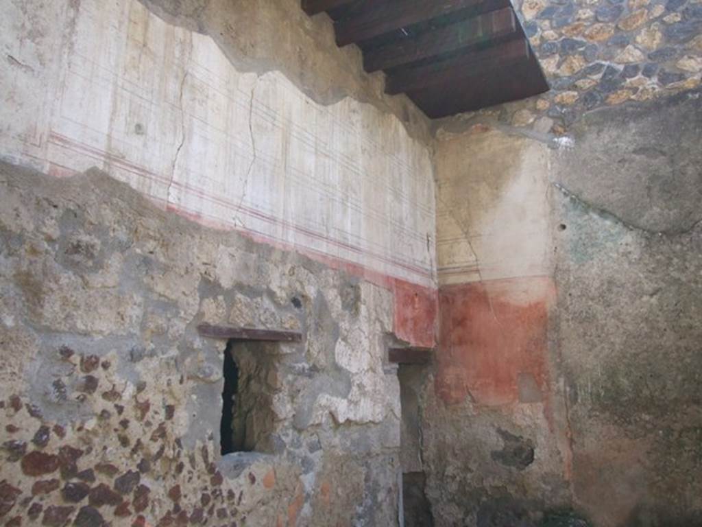 I.12.3 Pompeii.  March 2009.  South east corner of painted upper wall of passageway.
