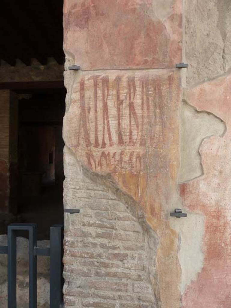 I.12.3 Pompeii. September 2015. Graffiti on the wall to west of door, without the benefit of a dirty piece of plastic sheeting.