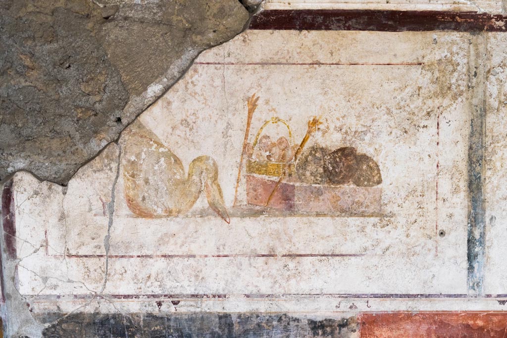 II.1.12 Pompeii. July 2021. 
Triclinium, upper panel on west wall at south end, with painting of a swan, a basket and two torches. Photo courtesy of Johannes Eber.
