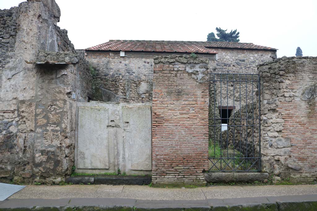 II.3.2, Pompeii, on left. December 2018. Entrance doorways on south side of Via dellAbbondanza. Photo courtesy of Aude Durand.