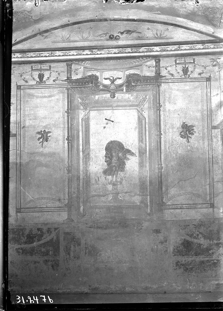 V.2.1 Pompeii. 1931? Room 8, looking towards west wall.
DAIR 31.2476 Photo  Deutsches Archologisches Institut, Abteilung Rom, Arkiv. 
The zoccolo was red subdivided with panels with carpet borders and garlands.
In the centre was Leda and the Swan in an aedicula with doors at each side and with an eagle on a globe above.
In the side panels were carpet borders, curved on the short sides and with cupids in the centre of each panel and above were goats and garlands.
In the lunette above were birds with fruit and with flowers at the sides.
See Carratelli, G. P., 1990-2003. Pompei: Pitture e Mosaici: Vol. III. Roma: Istituto della enciclopedia italiana, p. 776-7.
