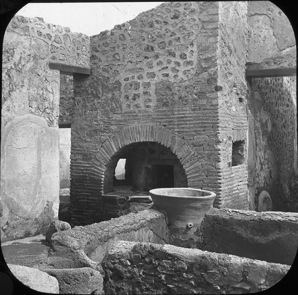 V.3.8 Pompeii. Looking south-east across bakery towards oven. 
Photo by permission of the Institute of Archaeology, University of Oxford. File name instarchbx202im 061. Source ID. 44552.
See photo on University of Oxford HEIR database
