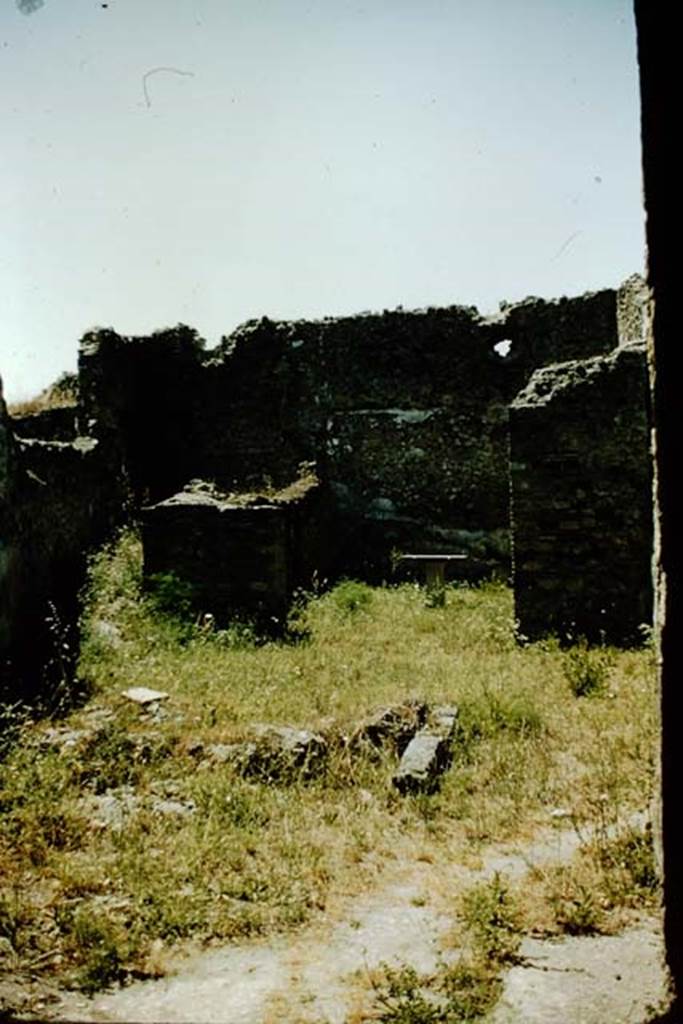 VI.7.23 Pompeii. 1957. Looking west across site of fountain towards doorway to storeroom and to triclinium, on right with table. Photo by Stanley A. Jashemski.
Source: The Wilhelmina and Stanley A. Jashemski archive in the University of Maryland Library, Special Collections (See collection page) and made available under the Creative Commons Attribution-Non Commercial License v.4. See Licence and use details.
J57f0343
