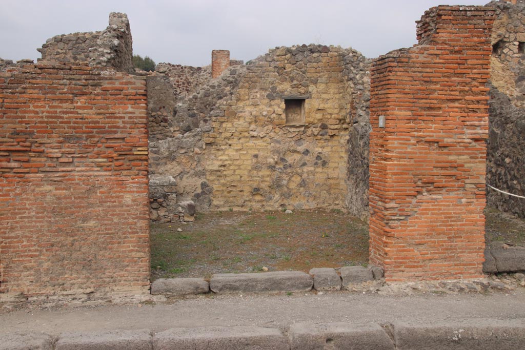 VI.14.4 Pompeii. October 2023. Looking north to entrance doorway on Via della Fortuna. Photo courtesy of Klaus Heese.