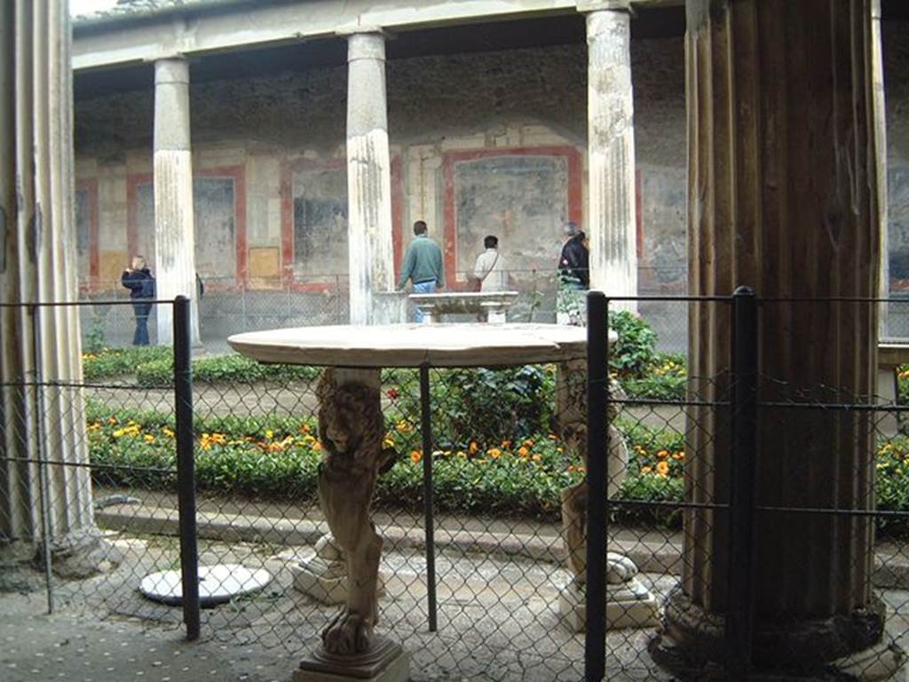 VI.15.1 Pompeii. December 2006.  Table with three lion legs in peristyle.