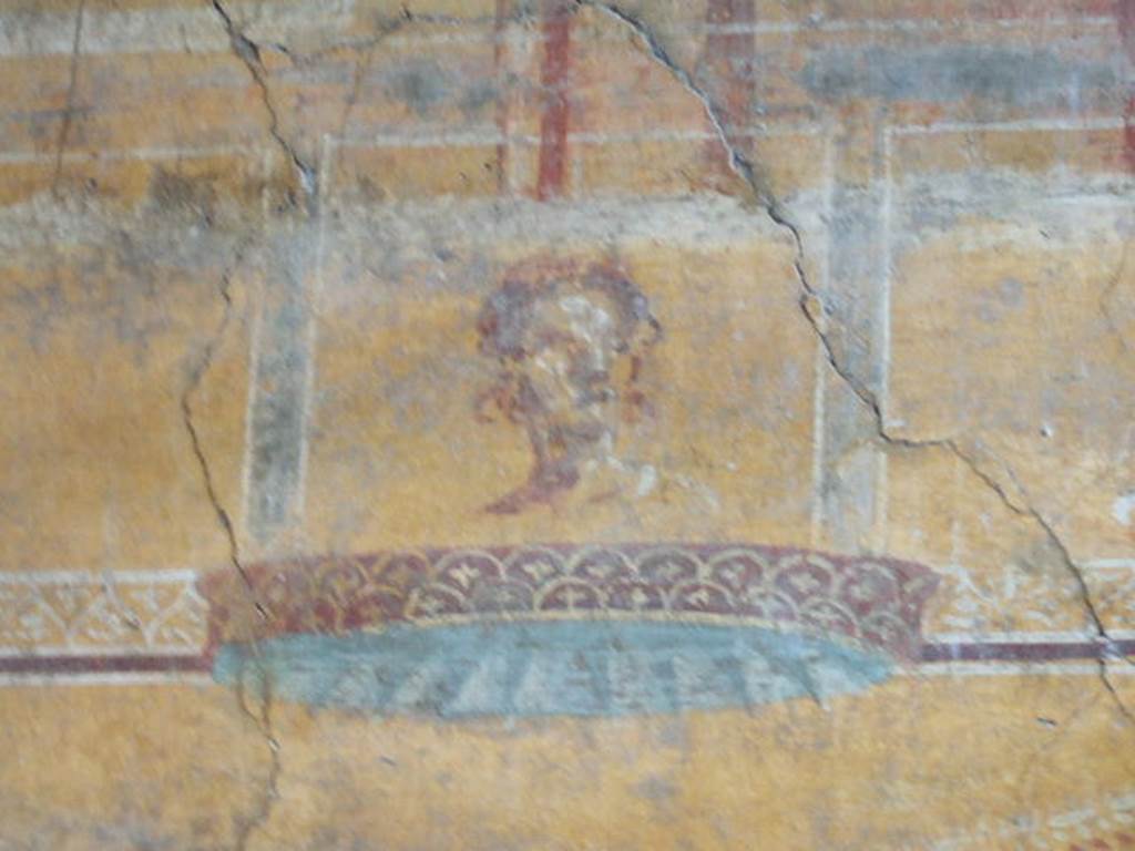 VI.16.7 Pompeii. May 2006. Room N, painting of face on north end of east wall.