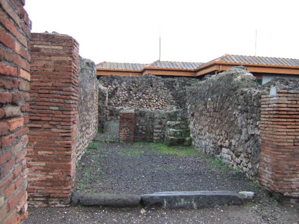VII.4.3 Pompeii. December 2005. Looking east from entrance. The steps to the upper floor can be seen in the south-east corner of the shop-room, on the right. The doorway to the rear room can be seen in the north-east corner, on the left.  In the rear room, against the east wall, there is a block of tufa stone, found on this was CIL IV 6602.  This block of stone can partly be seen through the doorway. The graffito read -
 M(arcum)  Artor(ium)  II v(irum)  [...]    [CIL IV 6602]
See Varone, A. and Stefani, G., 2009. Titulorum Pictorum Pompeianorum, Rome: Lerma di Bretschneider, (p.355 & photo XXVb)
Eschebach thought it may have been used as a podium ?
See Eschebach, L., 1993. Gebudeverzeichnis und Stadtplan der antiken Stadt Pompeji. Kln: Bhlau. (p.272)




