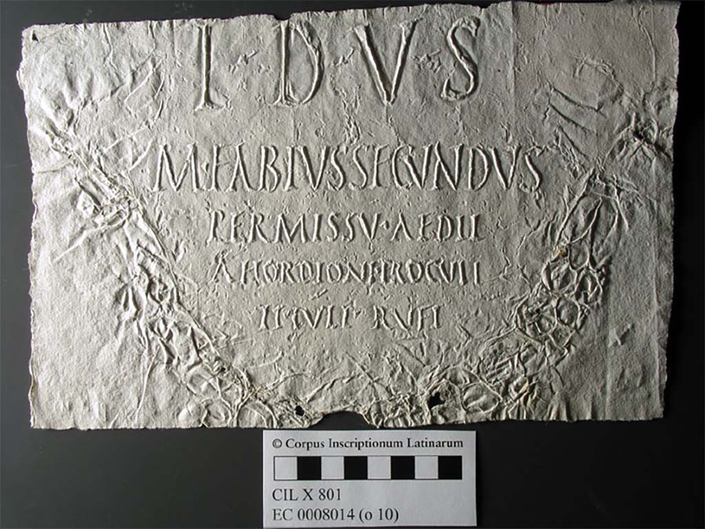 VII.7.32 Pompeii. Inscription image from Corpus Inscriptionum Latinarum.
See C.I.L. Archivum Corporis Electronicum Photographer unknown, CC BY 4.0

According to Epigraphik-Datenbank Clauss/Slaby (See www.manfredclauss.de) this reads
T(riviae?) d(eae) v(otum) s(olvit)
M(arcus) Fabius Secundus
permissu aedil(ium)
A(uli) Hordioni Proculi
Ti(beri) Iuli Rufi   [CIL X 801]

According to the Epigraphic Database Roma this reads
T(---) D(---) V(---) S(---)
M(arcus) Fabius Secundus,
permissú aedil(ium)
A(uli) Hordioni Proculi,
Ti(beri) Iúli Rufi.      [CIL X 801]
EDR lists several possible interpretations of T D V S including uncertain meaning of the letters.

