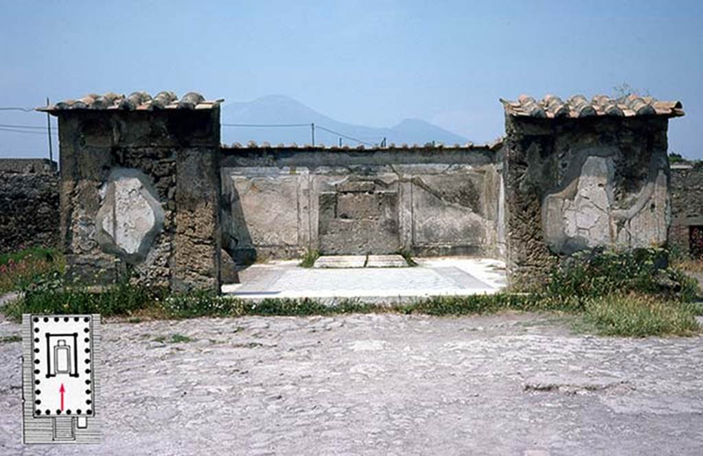 VII.7.32 Pompeii. June 1979 photo of the ruined cella (cult chamber) of the Temple of Apollo, Pompeii. The walls are preserved to only a fraction of their height, and are now protected by modern tiles. The floor was paved with white and black stone in a manner datable to the mid second-century BCE (the early date also indicated by an Oscan inscription that names the quaestor Oppius Campanus, not visible here). Just off to the left, inside the cella wall part of the ovoid stone, or omphalos (the navel) sacred to Apollo is visible. The base for the cult statue survives at the back of the cella (the statue was not found). The stucco covering of the walls is fairly well preserved inside the cella walls, and represents upright orthostats of faux marble . . . an indicator of the so-called First style of Campanian wall decoration (and another indicator of the date of the structure). The door jambs are of Sarno limestone; the cella walls constructed elsewhere of rubble masonry and concrete. 
The temple was probably awaiting reconstruction in 70 CE, having been damaged in the earthquake of 62 CE. This photo was taken in 1979 when public access to the temple was permitted. Photo Courtesy of Roger B. Ulrich.