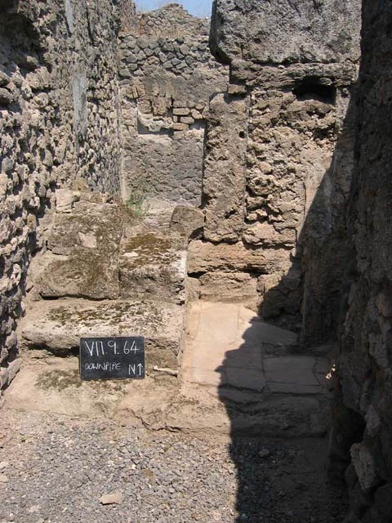 VII.9.64 Pompeii. July 2005. Looking north. Photo courtesy of Barry Hobson.
According to Hobson when writing next door to VII.9.63 a new entrance from the street was made. This gave access via a staircase to the upper storey, and to the right of the stairs another new latrine was constructed.  This was now back to back with the one in VII.9.63 and emptied into the same cesspit. In addition the staircase led to an upper storey latrine, the down pipe from which was inserted into the wall. The provision here of three latrines leads one to ask who used each of them?.  
See Hobson, B., 2009. Latrinae et foricae: Toilets in the Roman World. London; Duckworth. (p.68)

