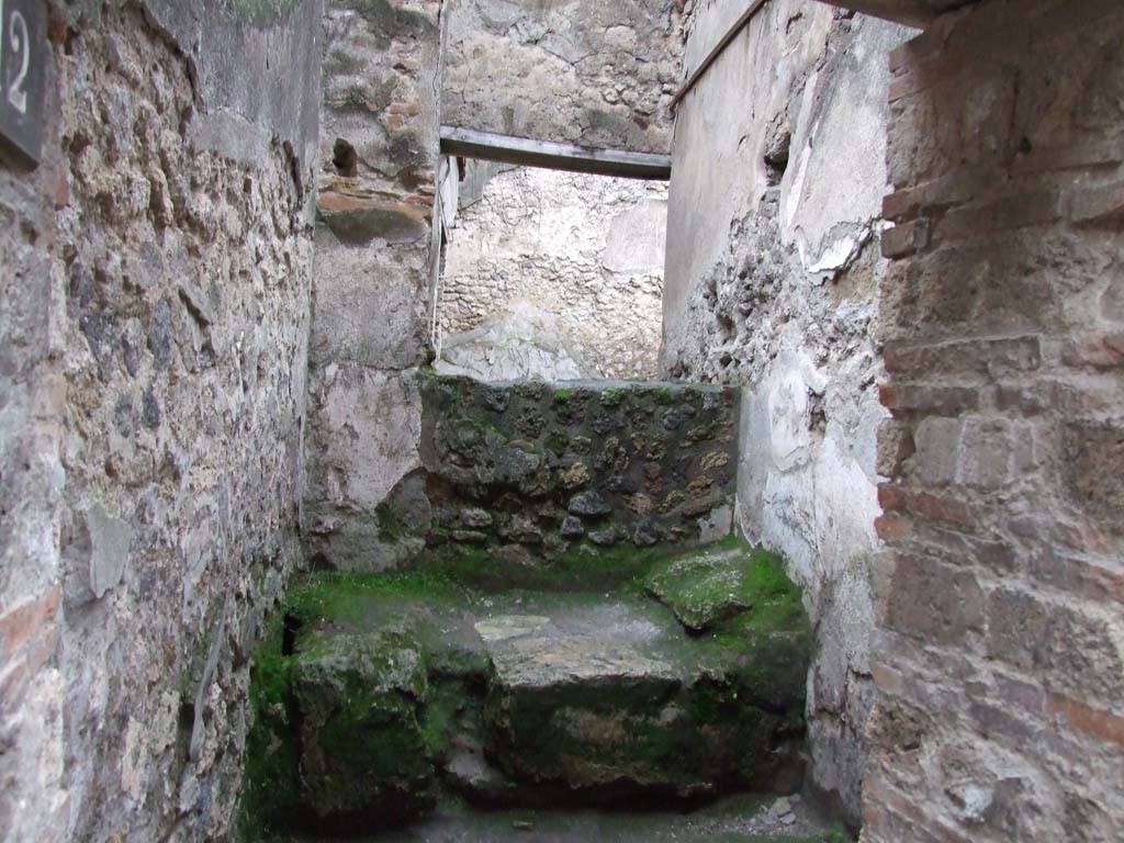 VII.11.12 Pompeii. December 2006. Cella meretricia with stone bed, under steps to upper floor.  
Traces of steps are visible on the wall on the right-hand side of picture.
