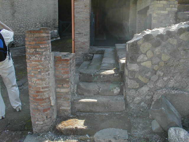VII.16.a Pompeii. May 2010.  Upper steps that would have led east, under the exterior portico.  The entrance to corridor B can be seen on the left.
