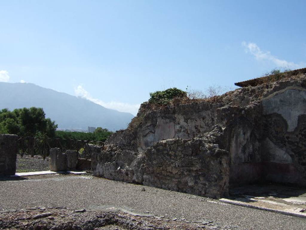 VIII.2.26 Pompeii. September 2005. 
South-west corner of atrium, with entrance to garden terrace ‘s’, and doorways to triclinium ‘n’ and cubiculum ‘o’.
(Note: our triclinium ‘n’ (and also PPM) is the same room as NdS room “q”, centre left in above photo.
Room “p” (as in NdS below), is the room in the south-east corner of the east side of the atrium, our room “m”.)
According to NdS –
“The room to the west of the tablinum, room "q" was similarly decorated to room “p”, with yellow background, black zoccolo and mosaic floor. 
In the middle of its west wall you could still see the remains of a painting, but even those remains were very destroyed: here one could see, just to the right a manly figure, naked except for a cloak around the loins, he was painted almost from behind, rising on his feet, and stretching as much as he could, stretched his arms to reach a height that was not well discerned. In the side panels of the walls were flying cupids.” 
Near to this room was the staircase "r" by which you descended to the floor beneath. 
See Notizie degli Scavi di Antichità, 1888, (p. 513).
