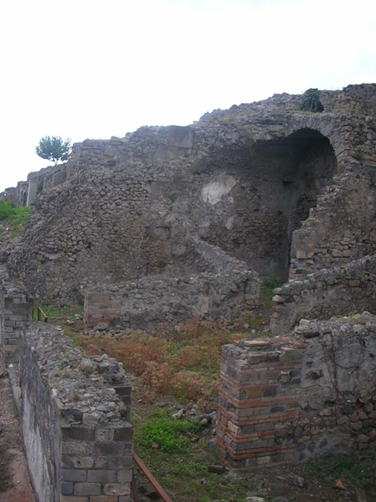 VIII.2.34 Pompeii. May 2011. 
Looking west across terrace towards room ‘11’, centre left, and vaulted room ‘6’, near ramp or steps of passageway ‘7’ from lower rear rooms.
Photo courtesy of Ivo van der Graaff.
