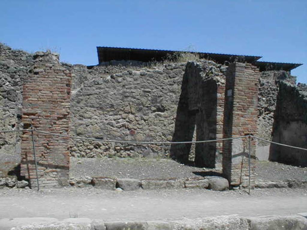 IX.1.10 Pompeii. May 2005. Entrance on Via Stabiana, looking east.
According to Della Corte, found on the pilaster between IX.1.9 or IX.1.10, pilaster on the left, was a painted recommendation, 
Fabritius  rog(at)    [CIL IV 958 ]
He said he could not know which of the two shops this Pompeian was established in.
See Della Corte, M., 1965.  Case ed Abitanti di Pompei. Napoli: Fausto Fiorentino. (p.210).
According to Pagano and Prisciandaro, the graffiti in black was found at IX.1.11 in July 1853.  This was probably the pilaster on the right between IX.1.10 and IX.1.11, and read:
Faustinum aed(ilem)
Fabritius rog(at)  [CIL IV 958]
See Pagano, M. and Prisciandaro, R., 2006. Studio sulle provenienze degli oggetti rinvenuti negli scavi borbonici del regno di Napoli. Naples : Nicola Longobardi. (p.169)
For the list of bronze, iron,terracotta, glass, bone and amphorae found in this shop,
See Gallo, A (2001). Pompei, LInsula I della Regione IX, Settore Occidentale (p.61), in SAP book no. 1 (LErma di Bretschneider)

