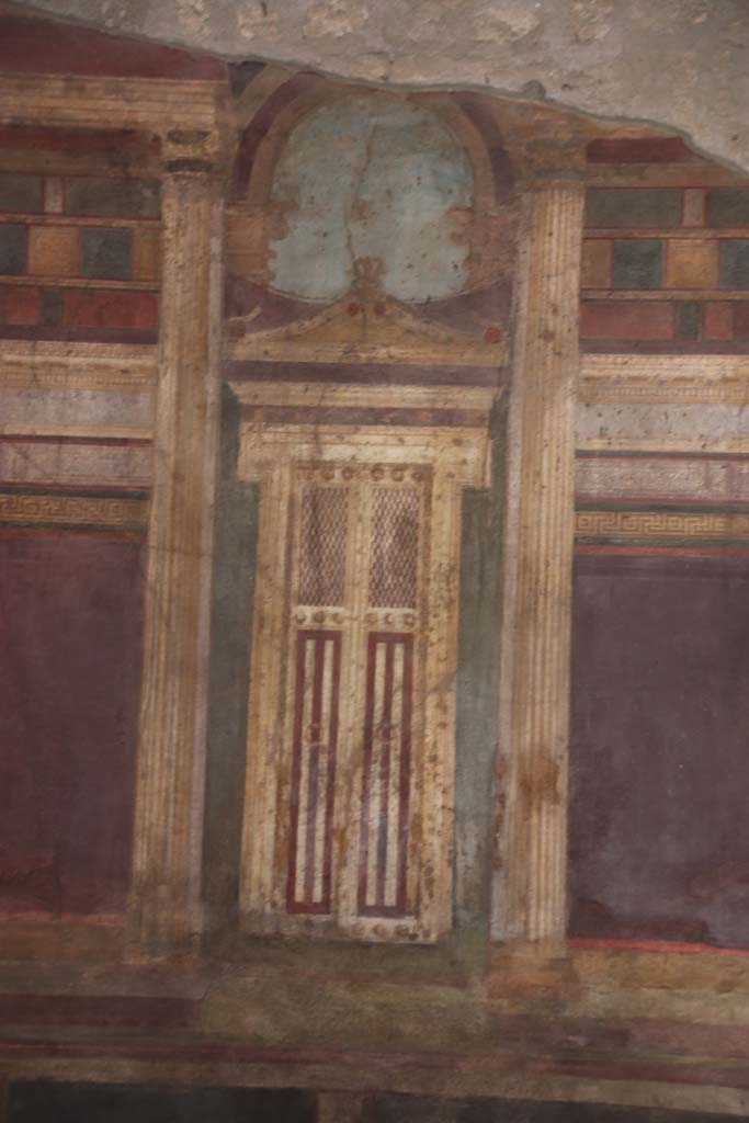 Villa of Mysteries, Pompeii. September 2021. 
Room 6, detail of painted doorway on north wall in oecus. Photo courtesy of Klaus Heese.
