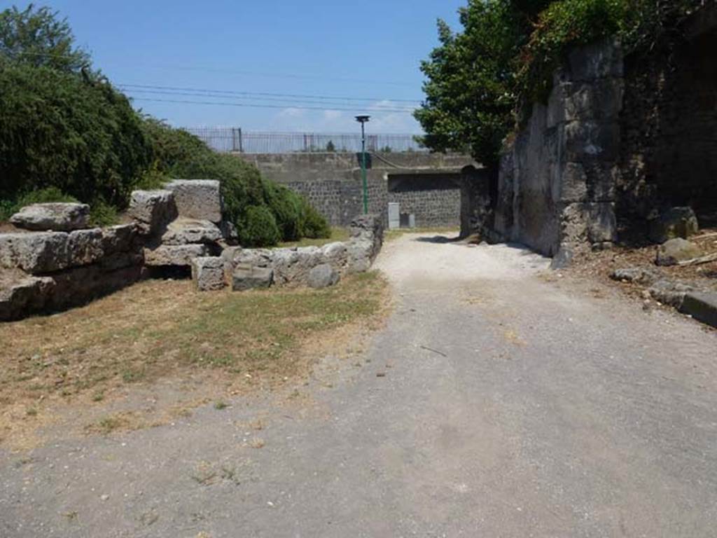 Via dell’Abbondanza between III.7 and II.5. June 2012. Looking east towards Sarno Gate. 
Photo courtesy of Michael Binns.
