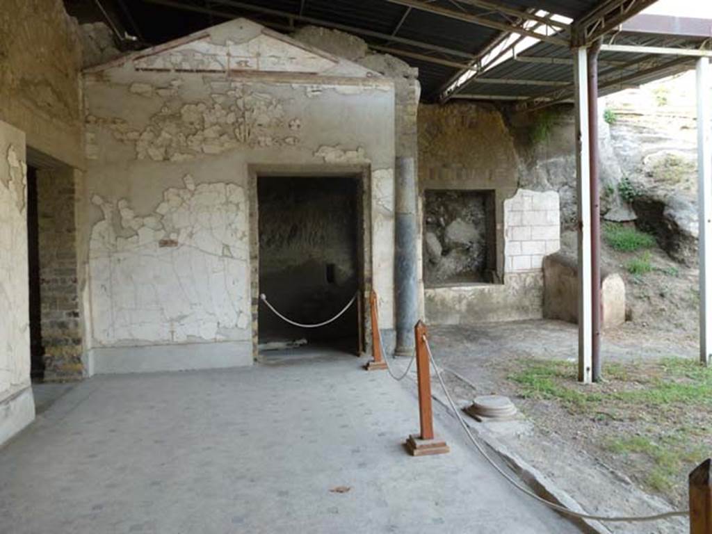 Oplontis, September 2011. Area 60, the west portico of the swimming pool.
This is the doorway at the north end, looking into the unexcavated, probably numbered 94. On the right is the window with the decoration under it, and a small wall built on its eastern side. Photo courtesy of Michael Binns.
