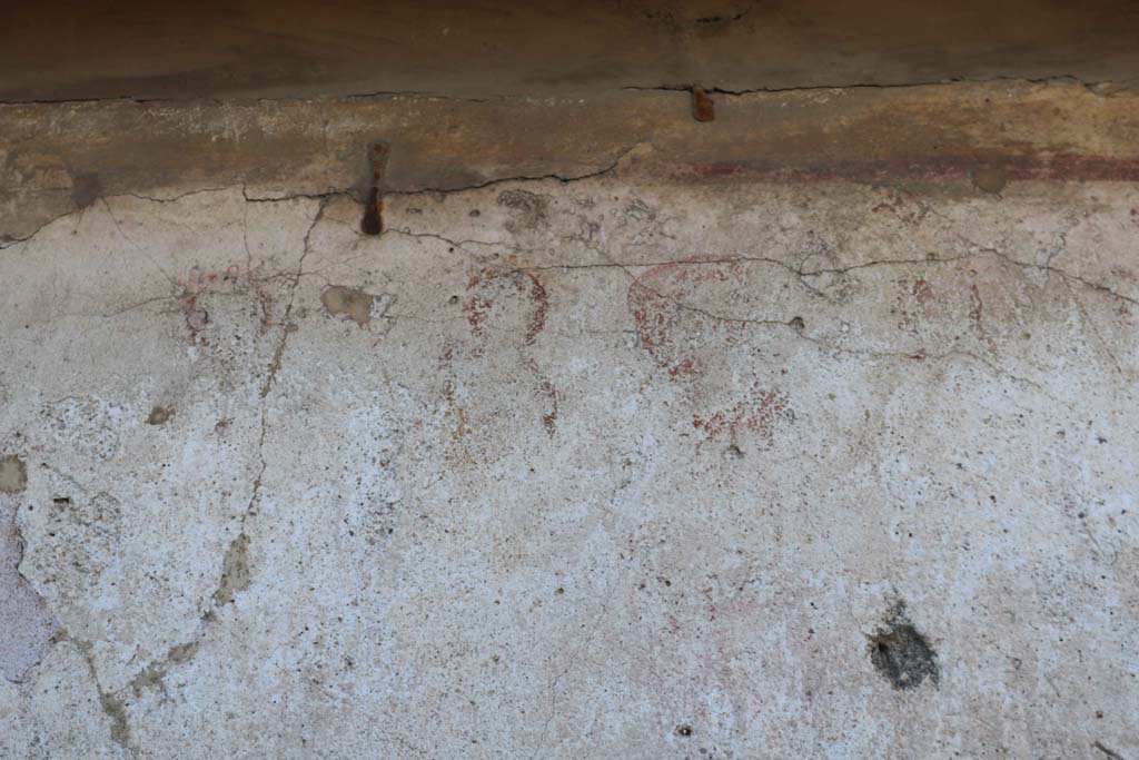 Detail of painted street shrine to twelve gods on corner of insula at VIII.3.11 in December 2018. 
South end. Photo courtesy of Aude Durand.