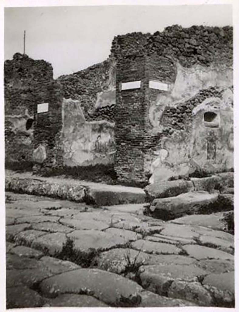 Street altar on SW side of IX.2.12 on Vicolo di Balbo, looking east from Via Stabiana. Pre-1943. 
Photo by Tatiana Warscher.
See Warscher, T. Codex Topographicus Pompeianus, IX.2. (1943), Swedish Institute, Rome. (no.43.), p. 102.