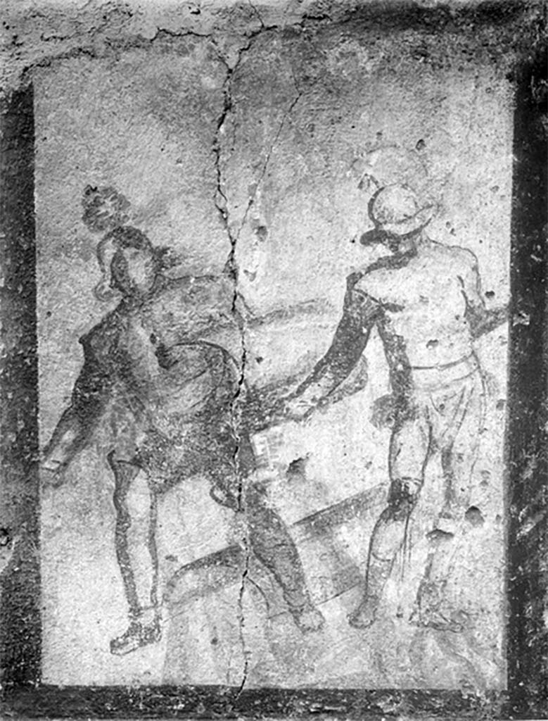 Street shrine outside IX.12.7. Detail from 1912 photograph.
Top left of the four paintings was a monochrome painting of two gladiators in combat.
According to Jacobelli, this represented the final encounter between two gladiators. 
Both were armed with curved rectangular shields, helmets and armbands. One wears high boots, the other a legging and a knee guard. 
The gladiator on the right had a bloody wound on his knee. Exhausted from combat, he was on the verge of collapse. 
The victor, probably a Thraex (Thracian), was using his shield to ward off his opponents last feeble blow.
See Jacobelli, L., 2003. Gladiators at Pompeii. Rome: L’Erma di Bretschneider. (p. 85; Figs 69-70).