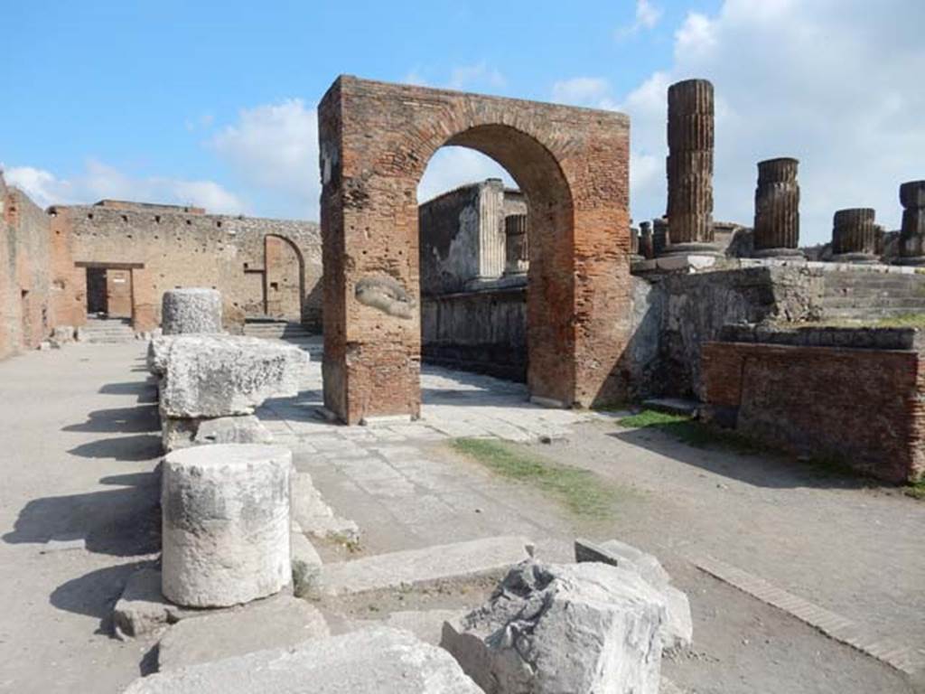 Arch of Augustus. May 2015. 
Looking north through the arch to the arched entrance leading into Vicolo dei Soprastanti, in the north-west corner of the Forum.
Photo courtesy of Buzz Ferebee.