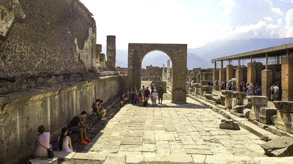 Arch of Augustus, on west side of Temple of Jupiter. August 2021. 
Looking south towards Arch of Augustus in north-west corner of Forum. Photo courtesy of Robert Hanson.