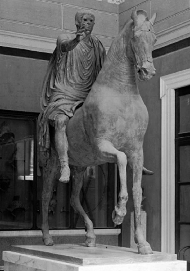 Arch of Caligula. Detail from 1895 photo of equestrian statue, found in pieces beneath the arch and rebuilt.
Now in Naples Archaeological Museum. Inventory number 5635.
