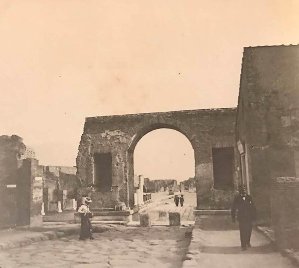 Arch at north-east end of the Forum, Pompeii. Undated photo (c.1900-1920). Looking south from Via del Foro through Arch into Forum. 
On the right is the area now occupied by the Restaurant.
Photo courtesy of Rick Bauer.