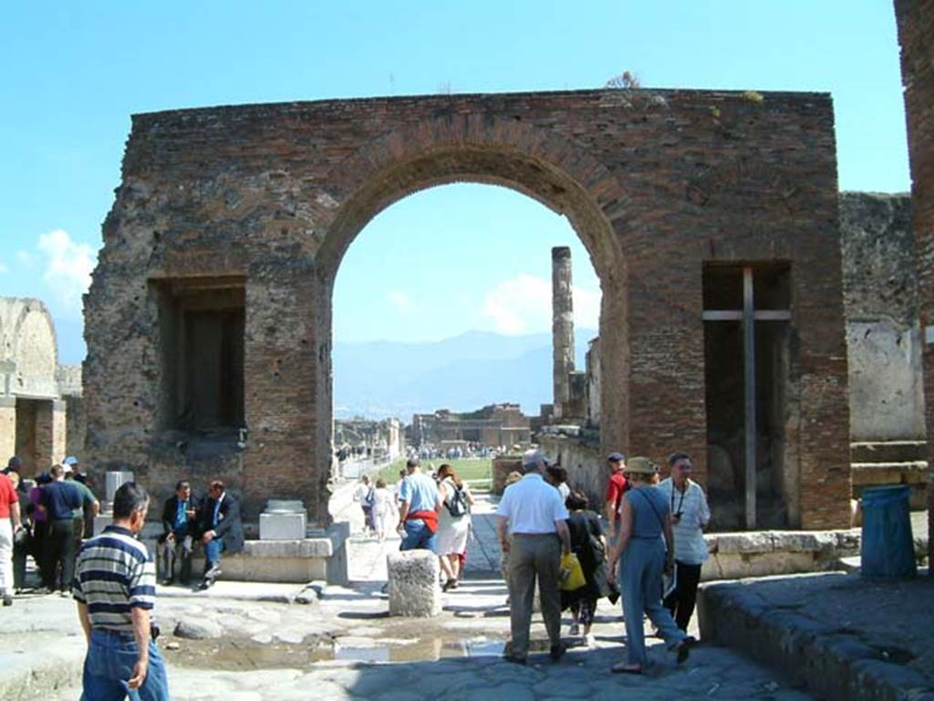 Arch at north-east end of the Forum. May 2002. North side with fountains. 
Looking south through arch from Via del Foro. Photo courtesy of David Hingston.