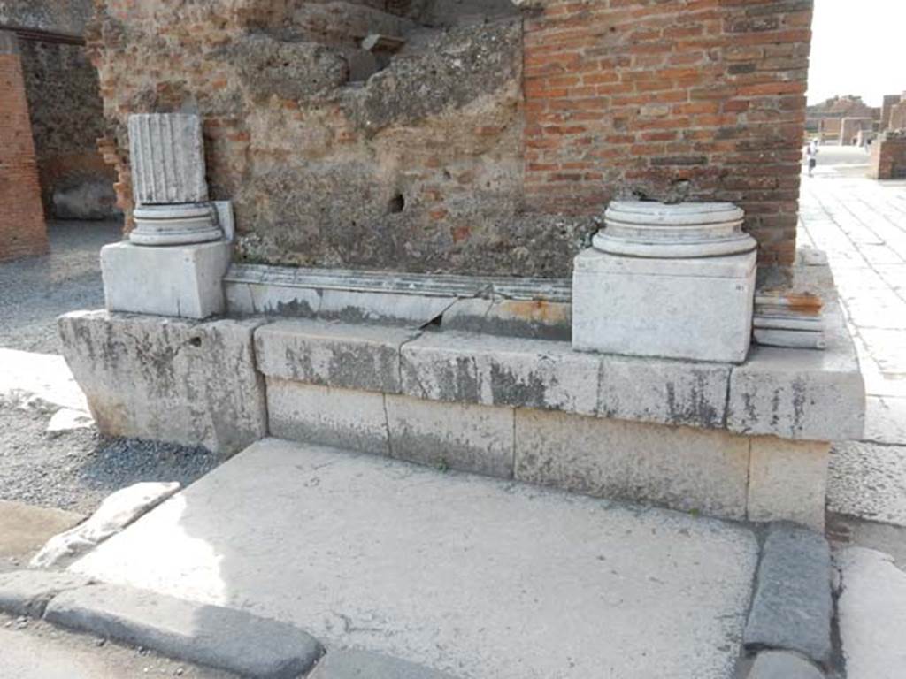 Arch at north-east end of the Forum. May 2015. Remains of marble base and pillars on north face of east side below fountain. 
Photo courtesy of Buzz Ferebee.