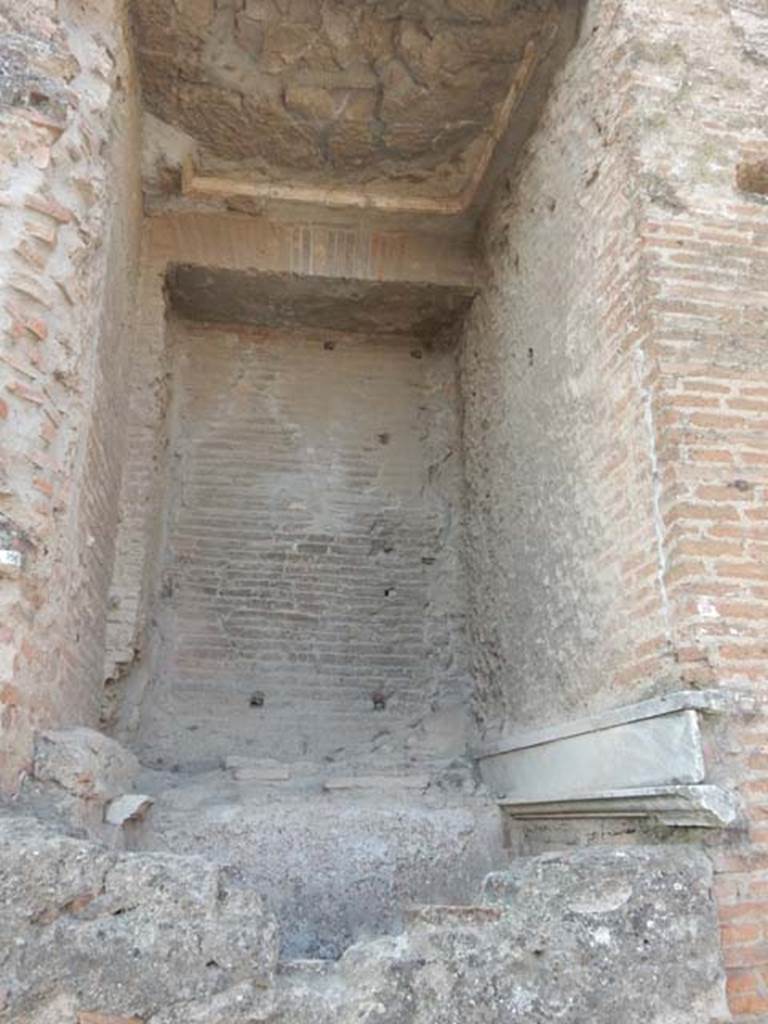 Arch at north-east end of the Forum. May 2015. Remains of marble and fountain on north face of east side. 
Photo courtesy of Buzz Ferebee.