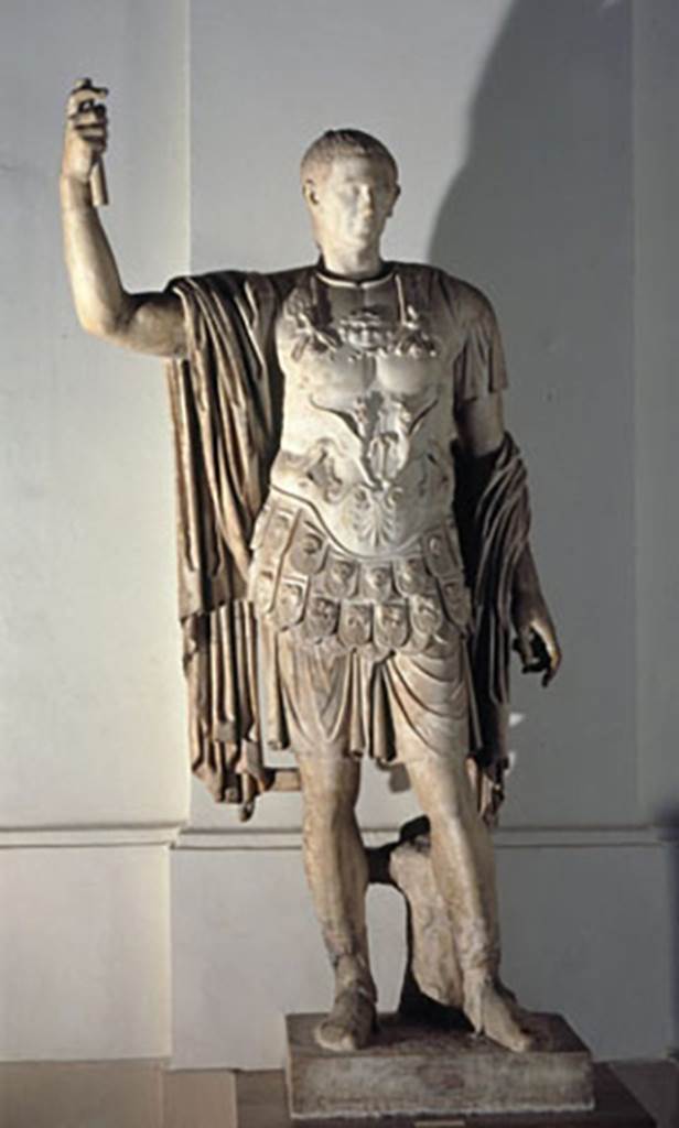 Arch of Marcus Holconius Rufus. Marble statue of Marcus Holconius Rufus.
Now in Naples Archaeological Museum. Inventory number 6233.
According to Cooley, Marcus Holconius Rufus was of equestrian rank, but his statue appropriated status symbols more correctly belonging to others.
He was in military dress even though he did not actually serve in the army in his role.
He was depicted wearing the sandals of a senator.
Colouring was visible when the statue was first found in 1853. 
His tunic was white edged with yellow, his cloak red and his shoes black.
The tree trunk supporting the statue was green. His hair, eyes and eyebrows were also coloured.
See Cooley, A. and M.G.L., 2004. Pompeii: A Sourcebook. London: Routledge. (Page 128, F89).