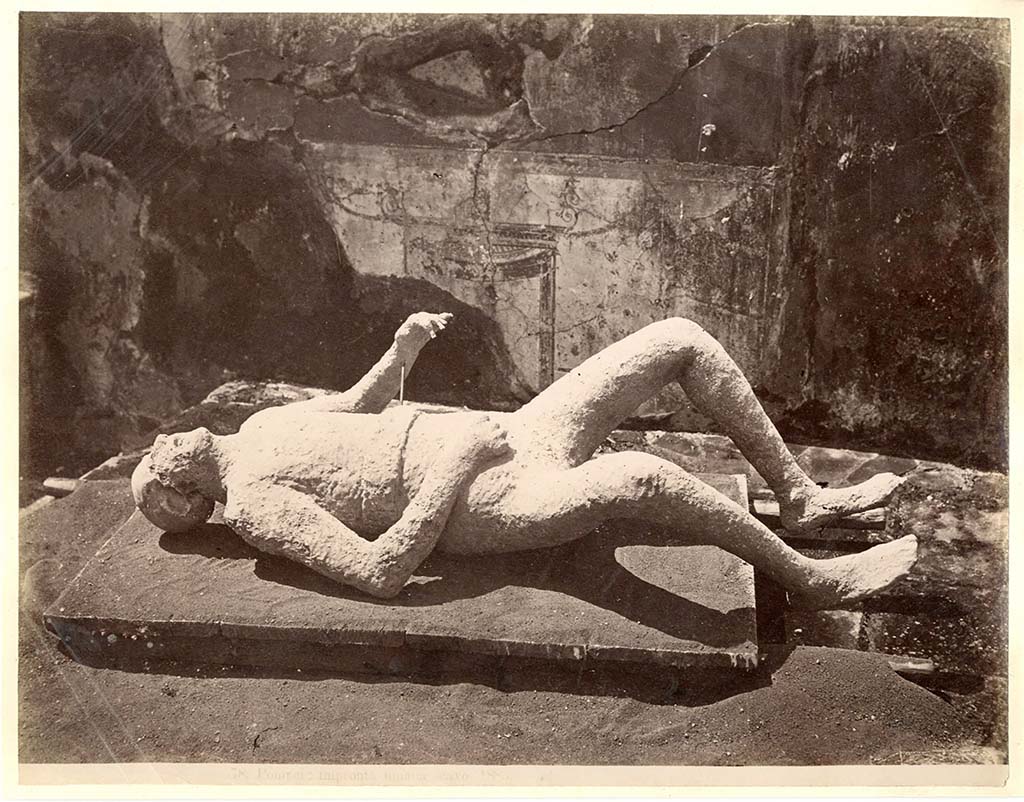 Known as Victim no.11, as this was the 12th to be successfully cast, and it was exhibited in the Antiquarium for some years. 
He was found on 28th December 1882, at a height of approximately four metres from the original soil level.
According to Dwyer, he had been fleeing along the top of the cinders at the time of his death.
He was found above the south-west corner of a garden, now numbered as VIII.6.6.
Near him were found two iron keys.
See Dwyer, E., 2010. Pompeii’s Living Statues. Univ. of Michigan Press: (p.103), the twelfth victim: the man with two keys.  
Garcia y Garcia gives the plaster cast number as 16.
See Garcia y Garcia, L., See Garcia y García, L., 2006. Danni di guerra a Pompei. Rome: L’Erma di Bretschneider. (p.194).
According to NdS –
“Insula 7, Reg. VIII. Inside and to the right of the fourth entrance on the north side, counting from the north-west, and at a height of about four metres from the soil, there appeared a human skeleton, of which was cast a model in gesso. Although the genitals do not appear, because they did not turn out, it seems from the features to be a man who, having fallen on his back, lies with his legs drawn up, his right hand to his breast, and his left arm somewhat raised. Near him were found two small iron keys, poorly preserved.”
See Notizie degli Scavi, 10, (1881-1882); p.606, (28th December 1862).

