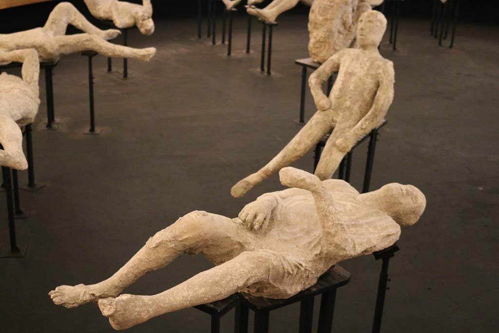 Pompeii Cast Project 2015. Victim number 15. Photo courtesy of Estelle Lazer.
According to Estelle Lazer, this victim was the sixteenth cast to be made. 
The cast was produced in 1890, when the victim was discovered outside the Porta Stabiana. 
It has been interpreted as a male. A popular interpretation is that this person was a beggar with a bag for alms. 
Very little skeletal material was observed, but there was enough to appreciate that what had previously been interpreted as a begging bag was in fact a miscast hand.
The impression of a very fine sandal on one foot seemed a bit of a discrepancy but this was explained away as a gift from a philanthropist.  
This victim was X-rayed. No bones were found in the head or the upper body.
This individual was consistent in age with a person in their teens. There was almost complete fusion of the distal epiphysis of the right tibia. 
Fusion of this bone is usually complete in females between fourteen and sixteen years of age and males between sixteen and twenty. 
The right calcaneal epiphysis was not completely fused. 
In modern Western populations, fusion of this bone begins between ten and twelve years in females and eleven and fourteen years in males. 
It is generally completed between fifteen and sixteen years of age in females and eighteen and twenty years in males.
Sex determination of sub-adults from the skeletal record tends to be unreliable.
See Lazer E., et al. 2020. Inside the Casts of the Pompeian Victims: Results from the First Season of the Pompeii Cast Project In 2015. Papers of the British School at Rome.
See Lazer E., 2009. Resurrecting Pompeii. Abingdon: Routledge, p. 117-119, p. 251-2, fig. 10.3.
