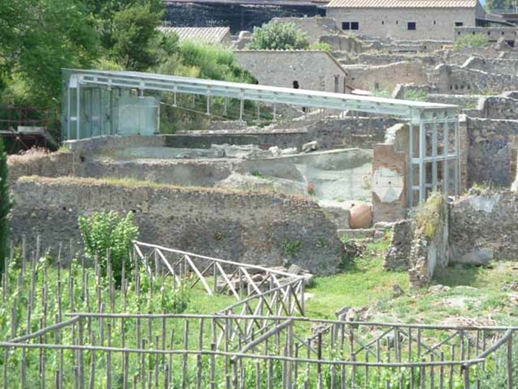 I.22.1 Pompeii. May 2010. Under the blue girders are the body casts found in 1989, on the layer of lapilli above I.22.1.