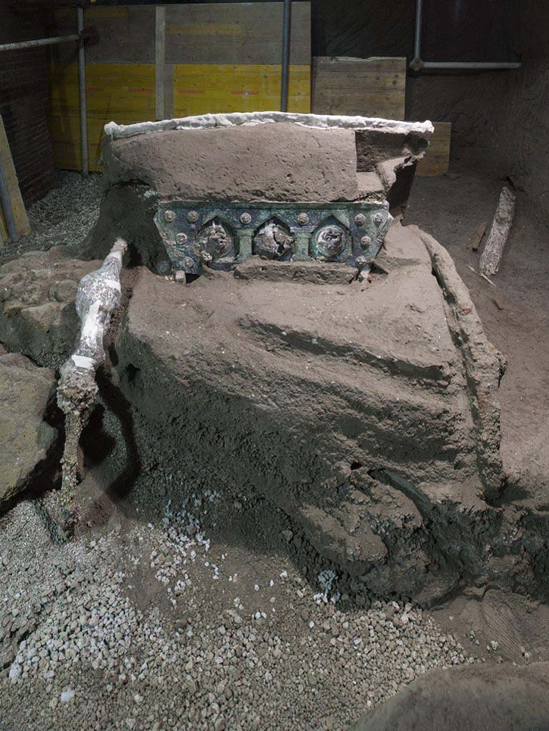 Cività Giuliana. February 2021. “It is an extraordinary discovery for the advancement of our knowledge of the ancient world”, declared Massimo Osanna, outgoing Director of the Archaeological Park, “At Pompeii vehicles used for transport have been found in the past, such as that of the House of Menander, or the two chariots discovered at Villa Arianna (one of which can be admired at the new Stabian Antiquarium), but nothing like the Cività Giuliana chariot.
What we have is a ceremonial chariot, probably the Pilentum referred to by some sources, which was employed not for everyday use or for agricultural transport, but to accompany community festivities, parades and processions. This type of chariot, which has never before emerged from Italian soil, bears comparison with finds uncovered around fifteen years ago inside a burial mound in Thrace (in northern Greece, near the Bulgarian border). One of the Thracian chariots is particularly similar to ours, even if it lacks the extraordinary figurative decorations that accompany the Pompeian find. 
The scenes on the medallions which embellish the rear of the chariot refer to Eros (Satyrs and nymphs), while the numerous studs feature erotes. Considering that the ancient sources allude to the use of the Pilentum by priestesses and ladies, one cannot exclude the possibility that this could have been a chariot used for rituals relating to marriage, for leading the bride to her new household.
Cività Giuliana. Febbraio 2021.  “E’ una scoperta straordinaria per l'avanzamento della conoscenza del mondo antico. – dichiara Massimo Osanna, Direttore uscente del Parco archeologico - A Pompei sono stati ritrovati in passato veicoli per il trasporto, come quello della casa del Menandro, o i due carri rinvenuti a Villa Arianna (uno dei quali si può ammirare nel nuovo Antiquarium Stabiano), ma niente di simile al carro di Civita Giuliana.
Si tratta infatti di un carro cerimoniale, probabilmente il Pilentum noto dalle fonti, utilizzato non per gli usi quotidiani o i trasporti agricoli, ma per accompagnare momenti festivi della comunità, parate e processioni. Mai emerso dal suolo italiano, il tipo di carro trova confronti con reperti rinvenuti una quindicina di anni fa all’interno di un tumulo funerario della Tracia (nella Grecia settentrionale, al confine con la Bulgaria). Uno dei carri traci è particolarmente vicino al nostro anche se privo delle straordinarie decorazioni figurate che accompagnano il reperto pompeiano. 
Le scene dei medaglioni che impreziosiscono il retro del carro rimandano all'eros (Satiri e ninfe), mentre le numerose borchie presentano eroti. Considerato che le fonti antiche alludono all’uso del Pilentum da parte di sacerdotesse e signore, non si esclude che potesse trattarsi di un carro usato per rituali legati al matrimonio, per condurre la sposa nel nuovo focolare domestico. 
Photograph © Parco Archeologico di Pompei.
