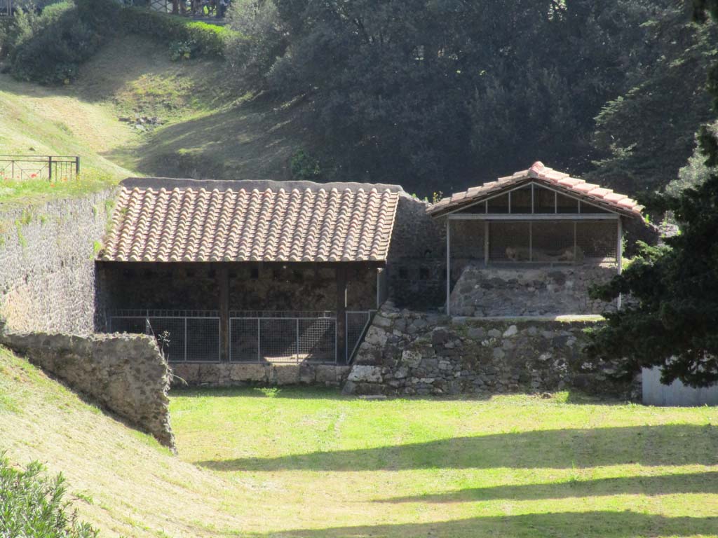 North-west side of Via delle Tombe. April 2019. 
Looking east towards display area showing the plaster-casts of some fleeing fugitives. 
Four victims were found between September 1956 and March 1957. Plaster casts were made. Photo courtesy of Rick Bauer.