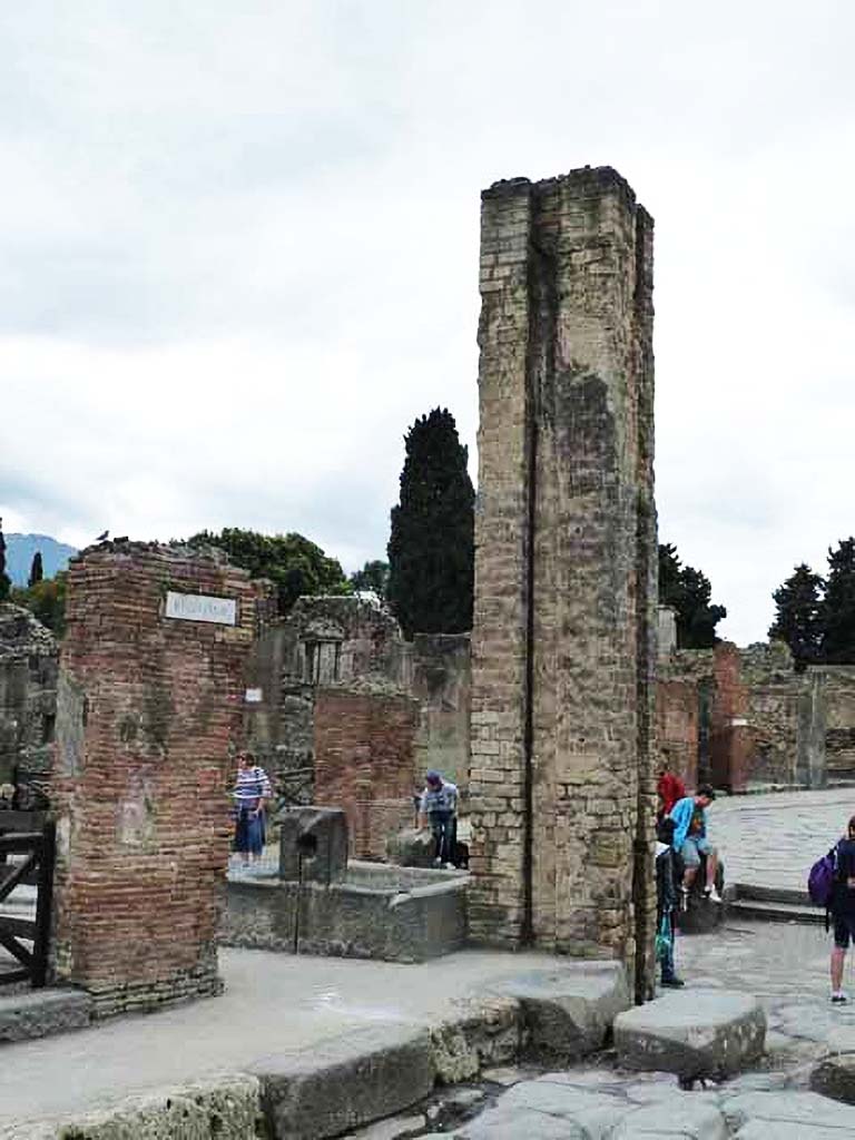 Fountain outside I.4.15 on Via Stabiana. May 2010. 
North and east sides of fountain and water column on the south side of the Via dell’Abbondanza, at the junction with Via Stabiana.