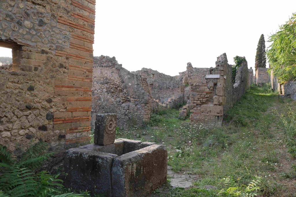 Fountain at 1.5.2, Pompeii. September 2018. 
Looking north-west across fountain towards entrance doorway of I.2.23 on Vicolo del Conciapelle. Photo courtesy of Aude Durand.