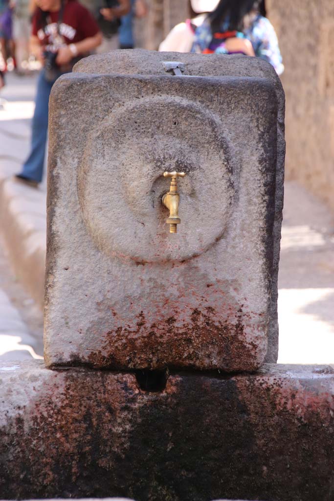 Fountain outside I.9.1 on Via dell’Abbondanza. September 2019. 
Relief of “patera” or plate on pilaster. Photo courtesy of Klaus Heese.
