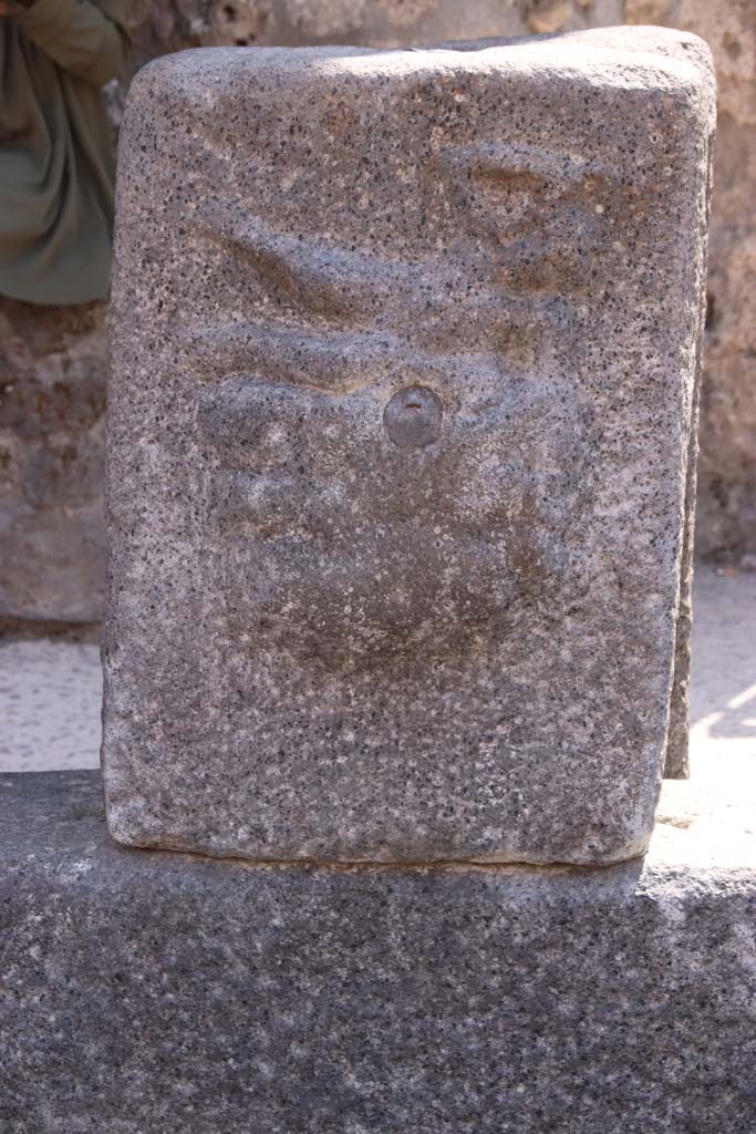 Fountain outside I.12.2 on Via dell’ Abbondanza. September 2019. 
Pilaster with relief of Satyr on rock-fountain or water source.
Photo courtesy of Klaus Heese.