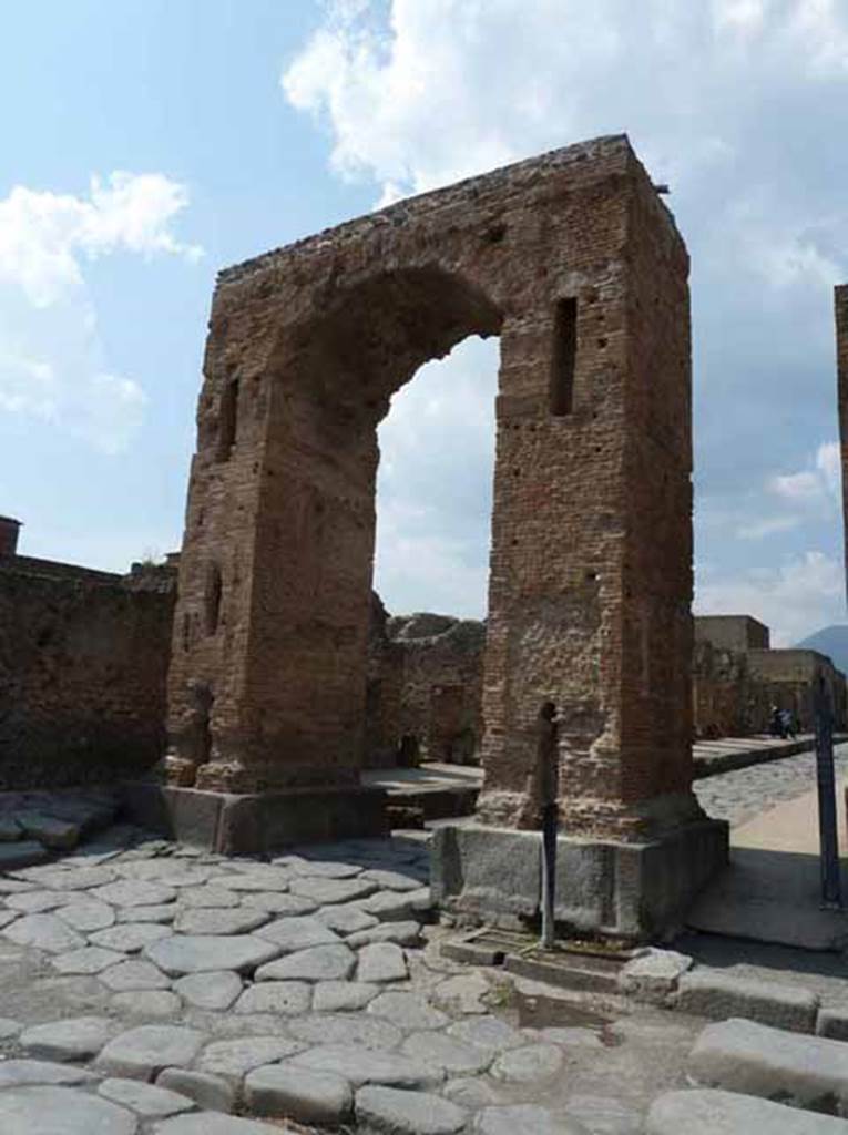 Arch of Caligula. May 2010. Looking north from arch at the start of the Via Mercurio. A bronze equestrian statue was found in pieces beneath the arch. This was (arbitrarily) identified as being Caligula and may have come from the top of the arch. Now in Naples Archaeological Museum.  Inventory number 5635.
According to Welch, the statue wore a toga and senatorial sandals and was realistically portrayed as middle aged. She suggested it was more likely to be a high ranking civic person. She suggested that it may be have been Marcus Tullius who was tribunus militum a populus a non military but equestrian rank. He was also the donor of the adjacent Temple of Fortuna Augustus in the Augustan period.
See Welch K. E. in Dobbins, J. J. and Foss, P. W., 2008. The World of Pompeii. Oxford: Routledge. (p.551-554, fig. 36.2a-c).