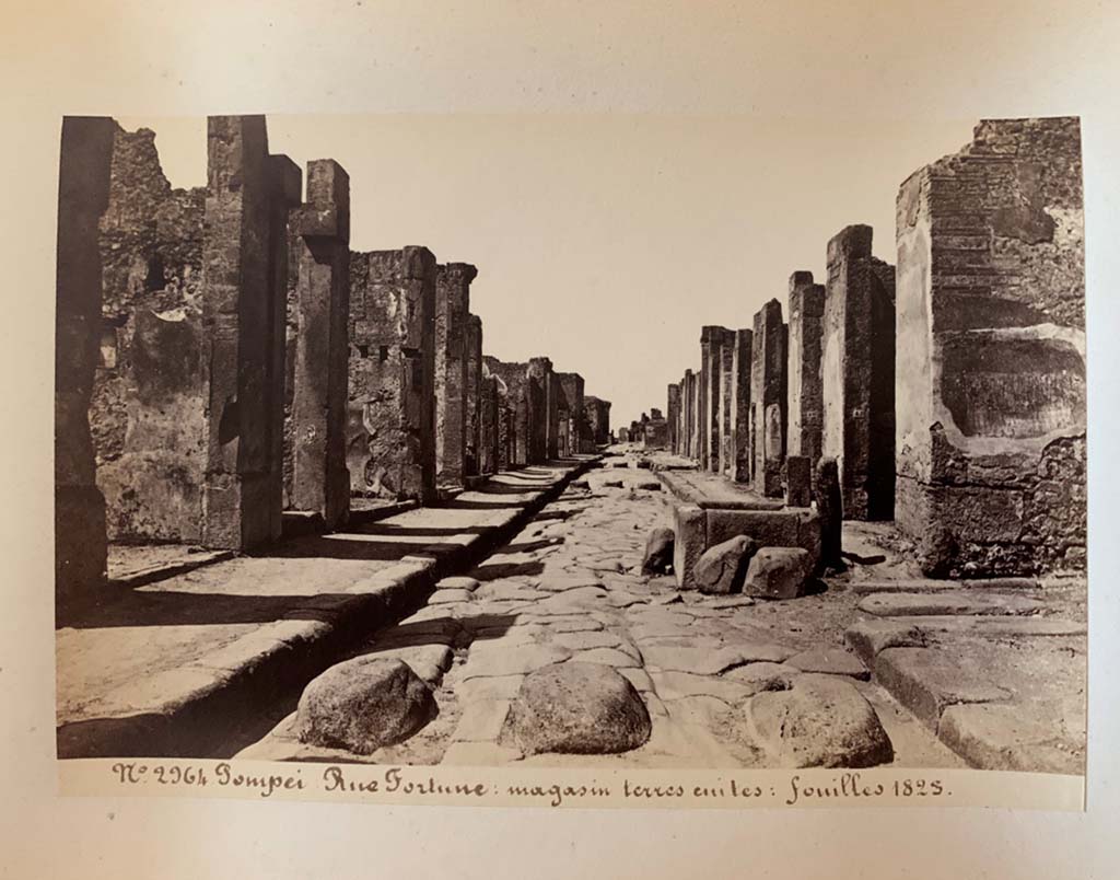 Fountain outside VI.13.7. Via della Fortuna, Pompeii. Photograph by M. Amodio, from an album dated April 1878.
Looking west towards fountain between VII.4 and VI.13, and junction with Vicolo dei Vettii, on the right. 
Photo courtesy of Rick Bauer.
