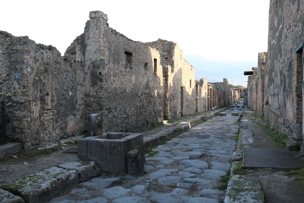 Fountain outside VI.16.28 on Vicolo dei Vettii. December 2018. 
Looking south to fountain outside VI.16.28, on left. Photo courtesy of Aude Durand.