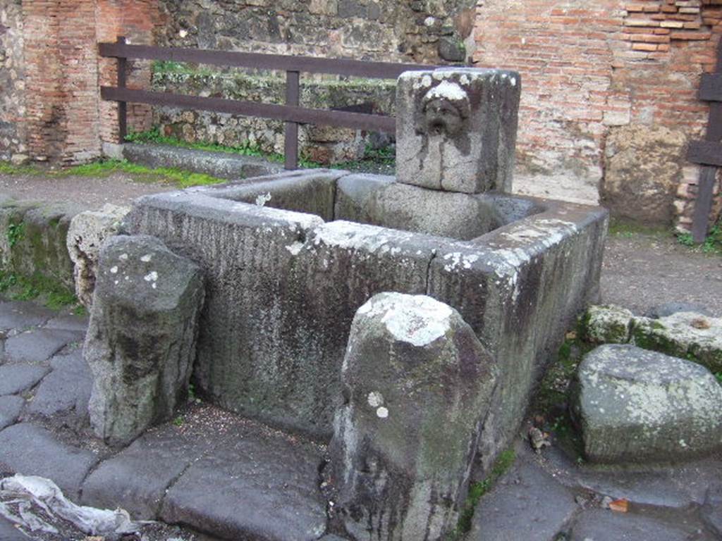 Fountain outside VII.1.32 and VII.1.33, December 2005. Looking south-west.
According to Eschebach, opposite the fountain was the street shrine of the lares compitales. See Eschebach, L., 1993. Gebäudeverzeichnis und Stadtplan der antiken Stadt Pompeji. Köln: Böhlau. (p.249)